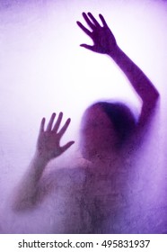 Trapped Woman Concept With Back Lit Silhouette Of Hands Behind Matte Glass, Useful As Illustrative Image For Human Trafficking, Prostitution, Imprisonment, Mental Illness, Captivity, Depression.