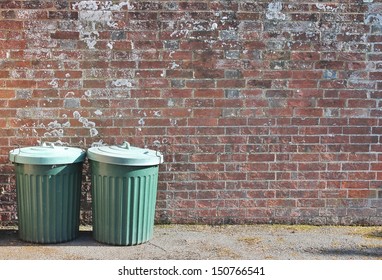 trash can dustbin rubbish bin garbage trashcan can outside against brick wall trash background with copy space - stock photo, stock photograph, image picture 