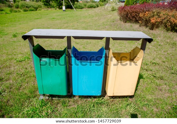Trash\
Containers for Garbage Separation , three colors for plastic,\
leftover food and paper. Three bright trash\
cans