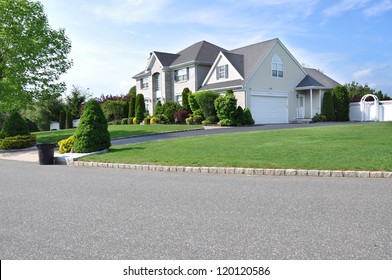 Trash Day Suburban Neighborhood McMansion Style House On Residential Street