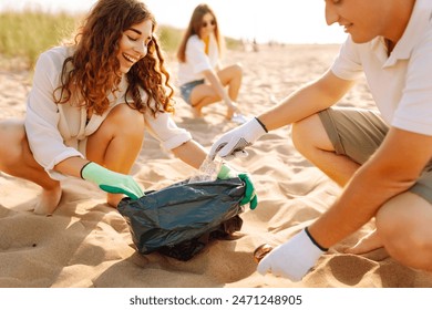 Trash on the beach. Volunteers activists collects garbage cleaning of beach coastal zone. Woman mans with trash in garbage bag on ocean shore. Earth day. - Powered by Shutterstock