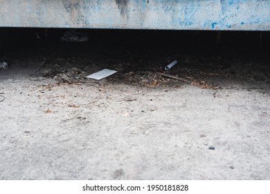 Trash And Papers In The Storm Drain At The Beach.