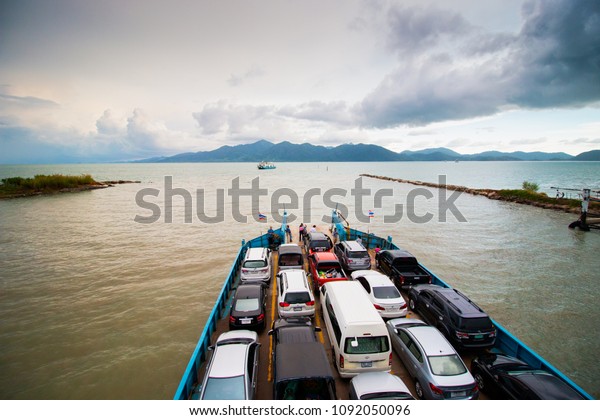 TRAT/THAILAND - APRIL 15: Cars Ferry boat in the sea\
 on 04 15 2018 in Ko Chang, Elephant Island Archipelago THAILAND.\
Southeastern region of Thailand. Getting to Koh Chang by boat can\
take the car.