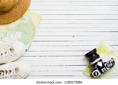 travel accessories on white wooden background