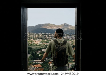 Similar – Image, Stock Photo Man traveling solo by train looking outside the window