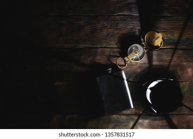 Travel or adventure flat lay background with a copy space. A flashlight, compass and water flask on a tourist table.