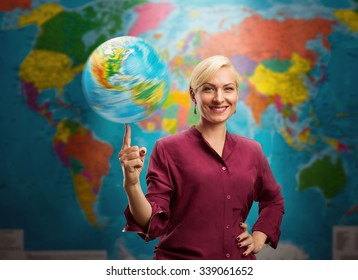 Travel agent woman with a globe against a map of the world