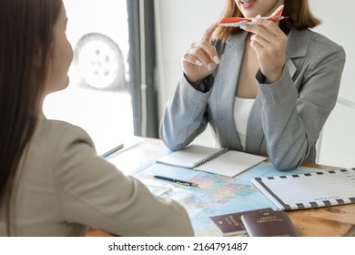 Travel Agent Woman Holding Airplane Toy Close Up At The Office. Concept Of Tourist Agency. Business Class On The Plane. First Class Flight Concept. Air Transportation Conceptual Photo.