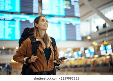 Travel, airport and excited woman with passport. travel ticket and documents for immigration, journey and flight schedule. Backpack person with identity document search for international registration