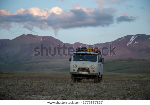 Travel in\
Altai republic by old uaz car at july 2019. Travel to Russia.\
Mountain hiking in the Altai. Active holiday with family and\
friends. Backpacks and equipment at the\
roof.