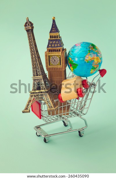 Travel around the world\
concept. Shopping cart with souvenir from around the world. Retro\
filter effect