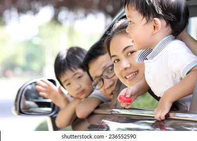 Travel Asian Family Preparing With Her Son In The Car