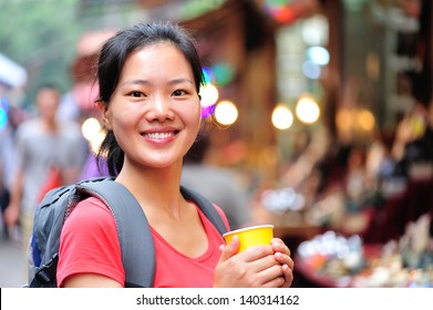 Travel Asian Woman With A Cup Of Coffee Smile At Street