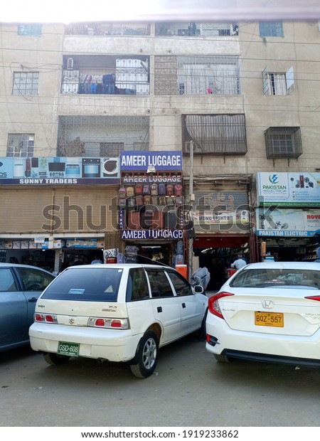 A travel bags and luggage shop with\
cars parked outside   - Karachi Pakistan - Feb\
2021