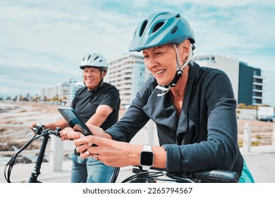 Travel, bike and senior people on a phone for fitness health app, cardio exercise progress and 5g network. Happy woman and partner or friends in lose weight journey on electric bicycle and smartphone - Powered by Shutterstock