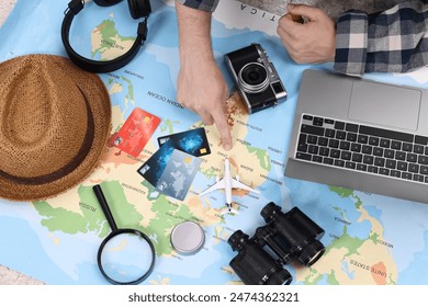 Travel blogger with laptop and map planning trip, top view - Powered by Shutterstock