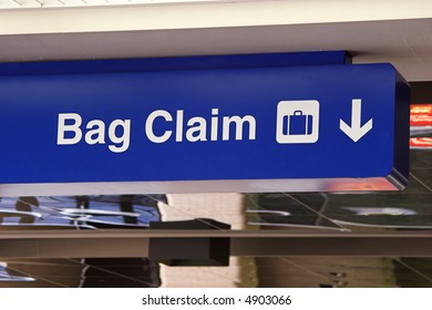 Travel. Blue Baggage Claim Sign At An Airport.