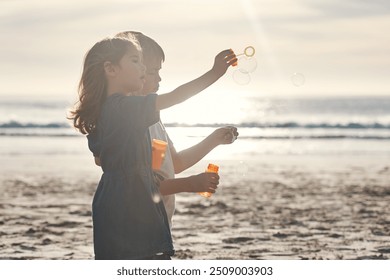 Travel, boy and girl with bubbles on beach for playing, summer and seaside game on holiday with fun. Children, siblings and together on vacation for adventure, childhood memories and bonding. - Powered by Shutterstock