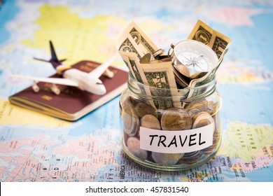 Travel budget concept. Travel money savings in a glass jar with compass, passport and aircraft toy on world map