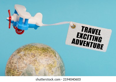 Travel And Business Concept. On A Blue Background, A Globe And An Airplane With A Sign - Travel Exciting Adventure. Globe Out Of Focus.