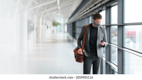 Travel business man wearing coronavirus face mask walking in airport using vaccine passport mobile phone app. Business travel professional people wearing face mask walking. technology coronavirus. - Powered by Shutterstock