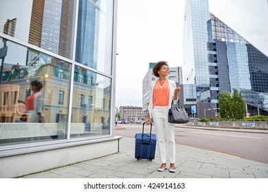 Travel, Business Trip, People And Tourism Concept - Happy Young African American Woman With Travel Bag On City Street