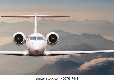 Travel By Aircraft. Airplane Fly Over Clouds And Alps Mountain On Down. Front View Of A Big Passenger Or Cargo Plane, Business Jet, Airline. Transportation Concept. Empty Space For Text