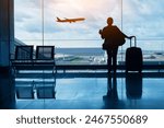 travel by plane, woman passenger waiting in airport, silhouette of passenger watching aircraft taking off