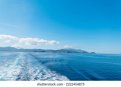 Travel by sea on a ship with a beautiful view of the island of Elba and the blue sky - Powered by Shutterstock