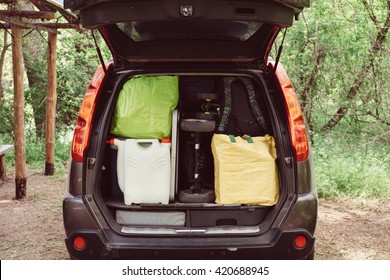 Travel And Camping Luggage Packed In The Car Trunk. Outdoor Wanderlust Items. Outdoor, Adventures And Travel Suv. Ready To Go Concept. Expedition, Exploring Swag And Storage.   