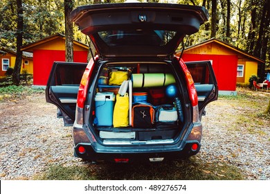 Travel Car And Camping Luggage Packed In The Full Car Trunk. Outdoor Wanderlust Items. Outdoor, Adventures And Travel Suv. Ready To Go Concept. Camping Exploring. Summer Season.