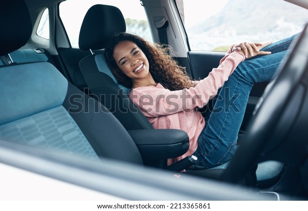 Travel, car passenger and black woman relax on\
road trip for fun journey, peace or open road freedom. Happy, smile\
and portrait of gen z girl in SUV van for transportation adventure\
in San Francisco