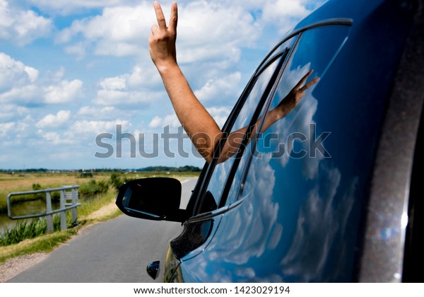 travel car with stretched
human hand 