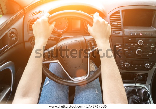 Travel car trip on road at sunset. Happy young\
woman have fun driving inside vehicle in summer sunny day. Driver\
ride vacation concept.