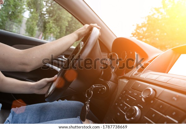 Travel car trip on road at sunset. Happy young\
woman have fun driving inside vehicle in summer sunny day. Driver\
ride vacation concept.