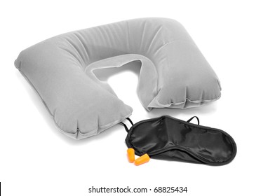 Travel Cervical Pillow, Earplugs And Mask Isolated On A White Background