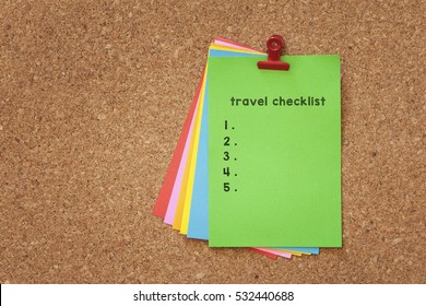 Travel Check List Written On Color Sticker Notes Over Cork Board Background