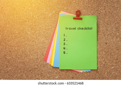 Travel Check List Written On Color Sticker Notes Over Cork Board Background