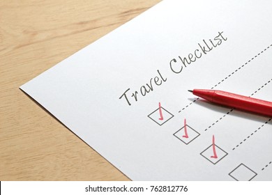 Travel Checklist Paper With Red Pen Marking On Tick Box.