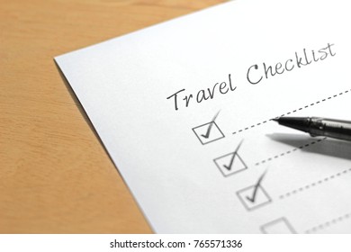 Travel Checklist Paper With Red Pen Marking On Tick Box.