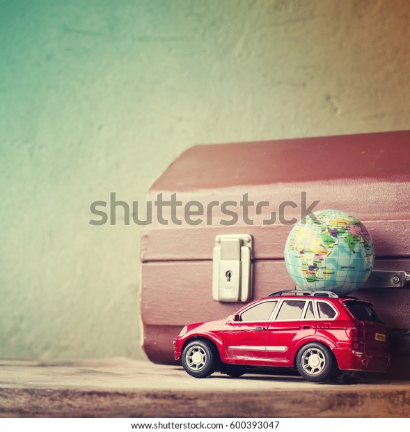 Travel concept background with casesuit, globe and\
car in vintage tone