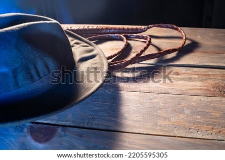 Travel concept background Indiana Jones style hat and the whip