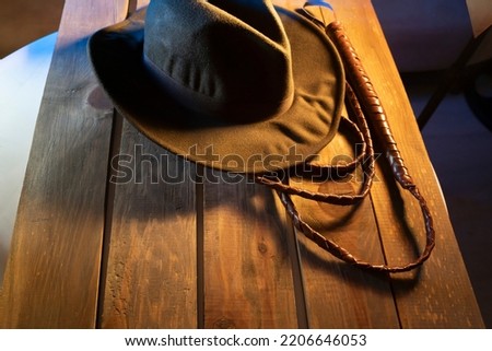 Travel concept background Indiana Jones style hat and the whip