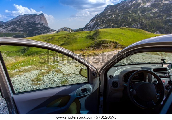 travel concept. the car with the door open on a\
background of mountains