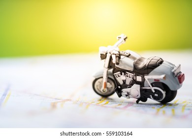 Travel Concept. Close up of motorcycle toy on map with daylight