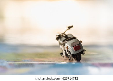 Travel Concept. Close up of motorcycle toy on map.