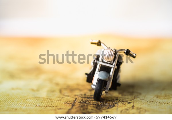 Travel\
Concept. Close up of motorcycle toy on\
map.