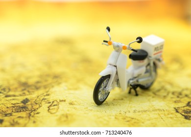 Travel Concept. Close up of vintage motorcycle toy on map.