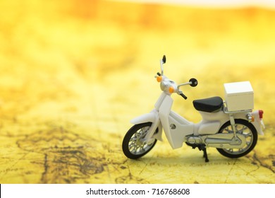 Travel Concept. Close up of vintage motorcycle toy on map.