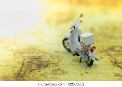 Travel Concept. Close up of vintage motorcycle toy on map.